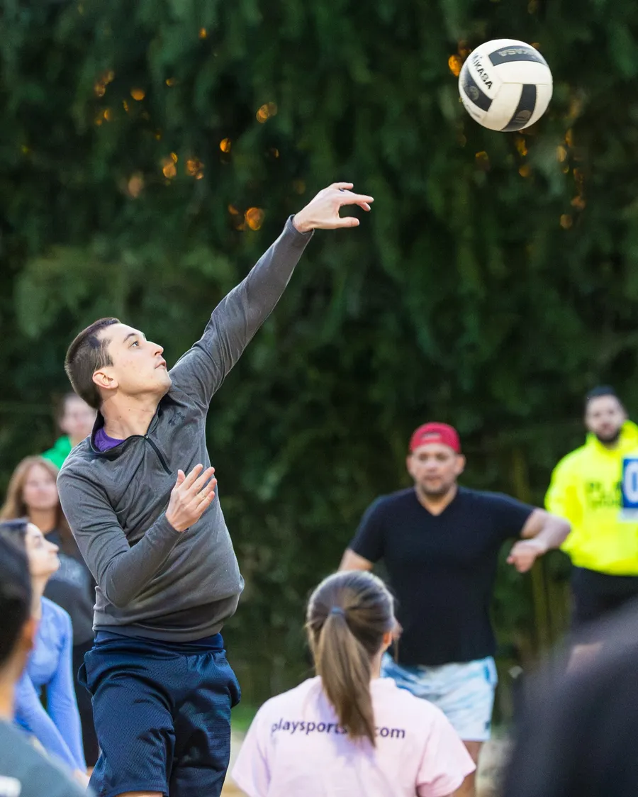 Cliff serving in a volleyball league match