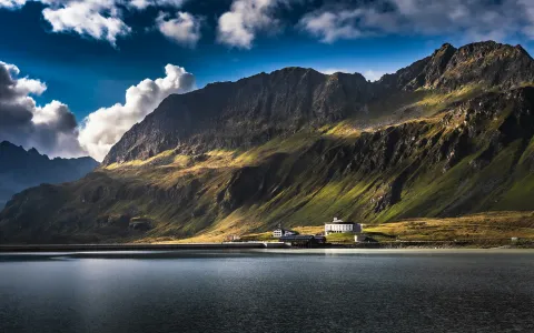 brown and green mountain beside body of water during daytime by Marek Piwnicki courtesy of Unsplash.